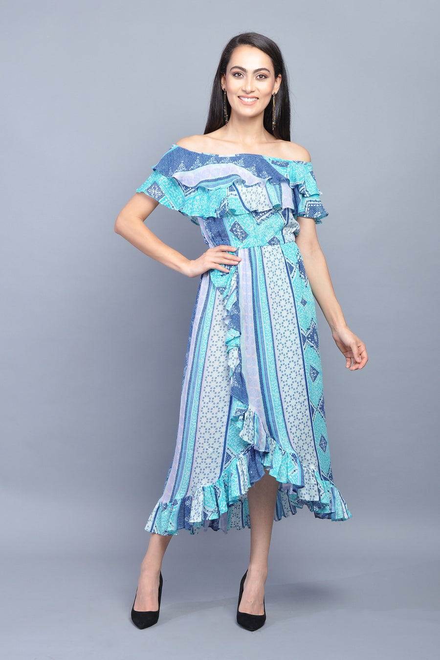 Woman wearing an off-shoulder ruffle midi dress in blue and turquoise patchwork print
